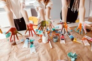 Children demonstrating their palms painted with watercolor